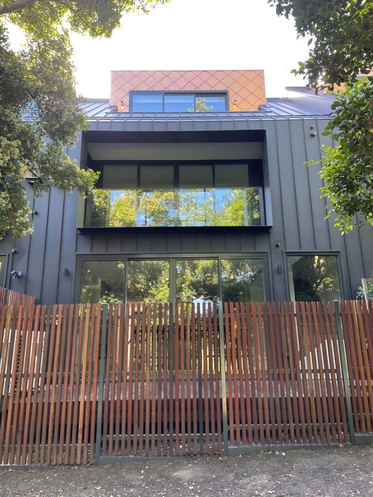 Modern black-cladded home exterior by PJ Thomas Homes